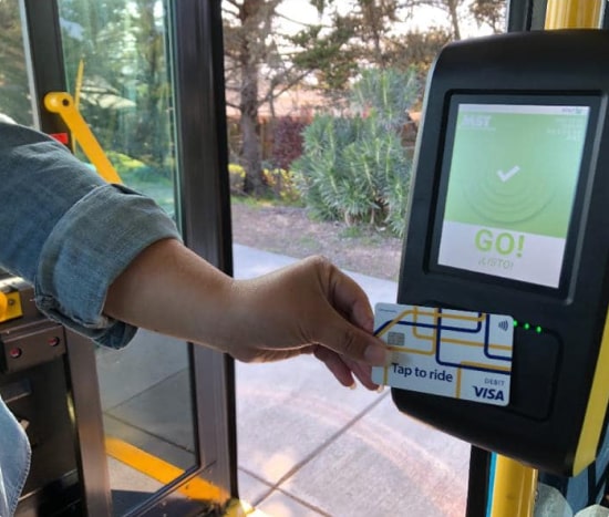 Woman holding handheld payment machine